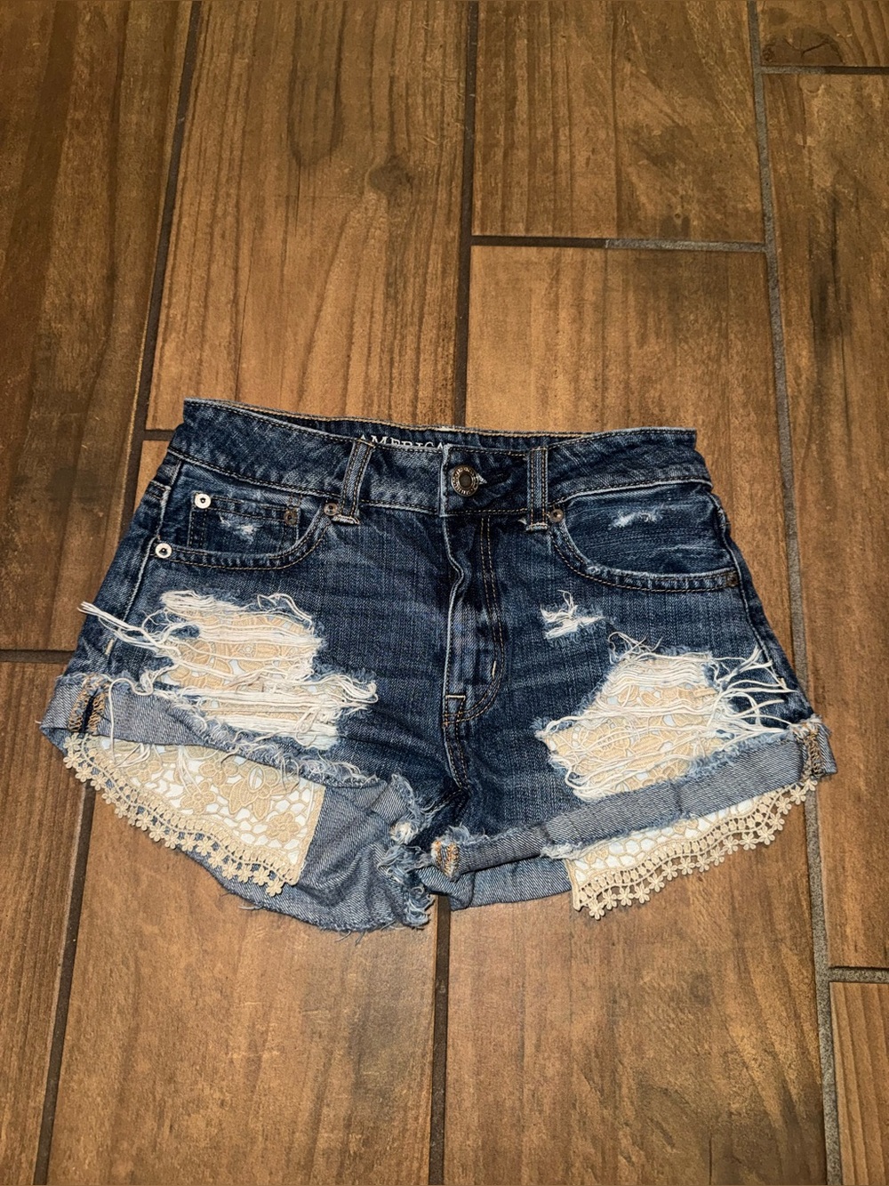 American Eagle hi-rise festival denim shorts featuring lace crochet pocket